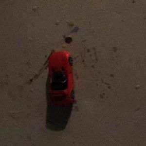 A hot wheel car that is red